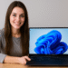 HP EliteBook Ultra G1i laptop running Windows 11, shown by a smiling user at a desk, featuring a slim, thin‑bezel display and sleek ultrabook design.