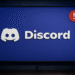 Error No Route en Discord - Discord logo on a blue screen with a red exclamation notification badge, suggesting a chat app alert or issue on a desktop monitor.